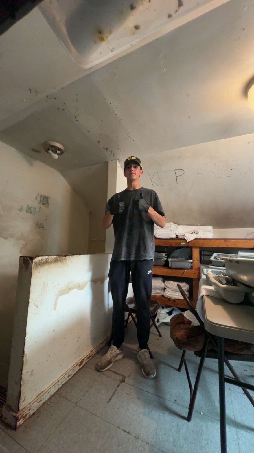Ethan Ricco of PGE Junk Removal giving a thumbs up during a cleanout